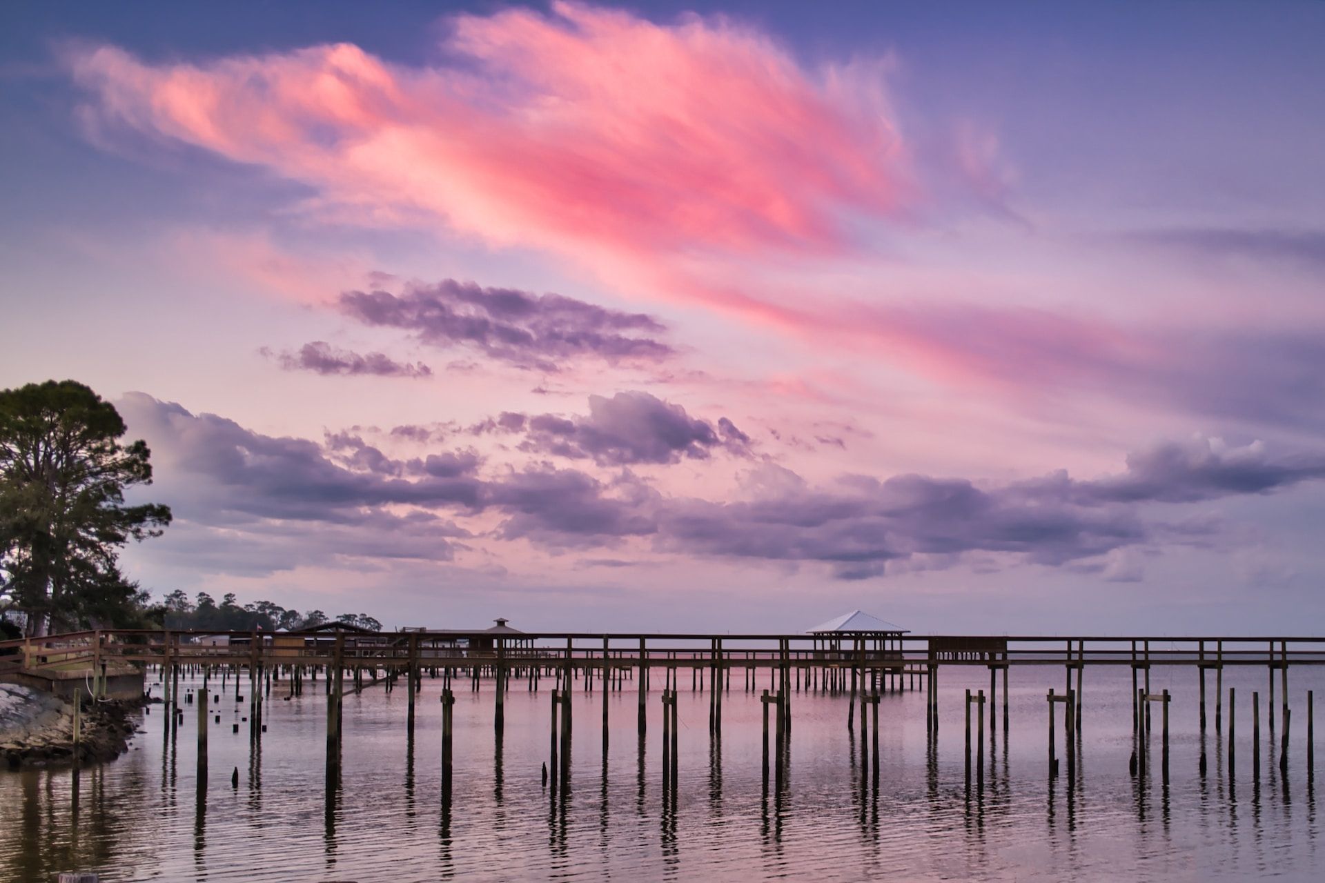Pink and blue clouds during a sunset over the docks of Fairhope