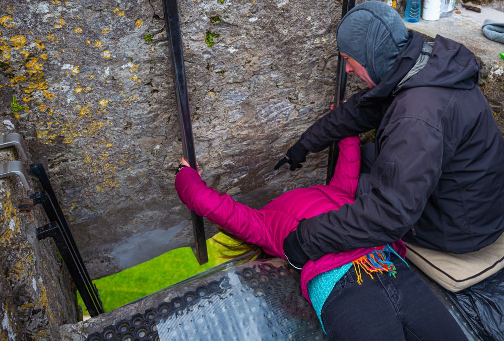 Woman trying to kissing the Blarney stone