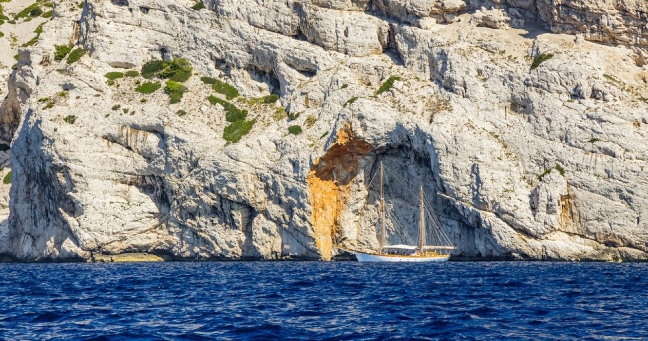 Beautiful two-masted sailboat in Calanque of la Triperie, located near Cape Morgiou in Marseille, France