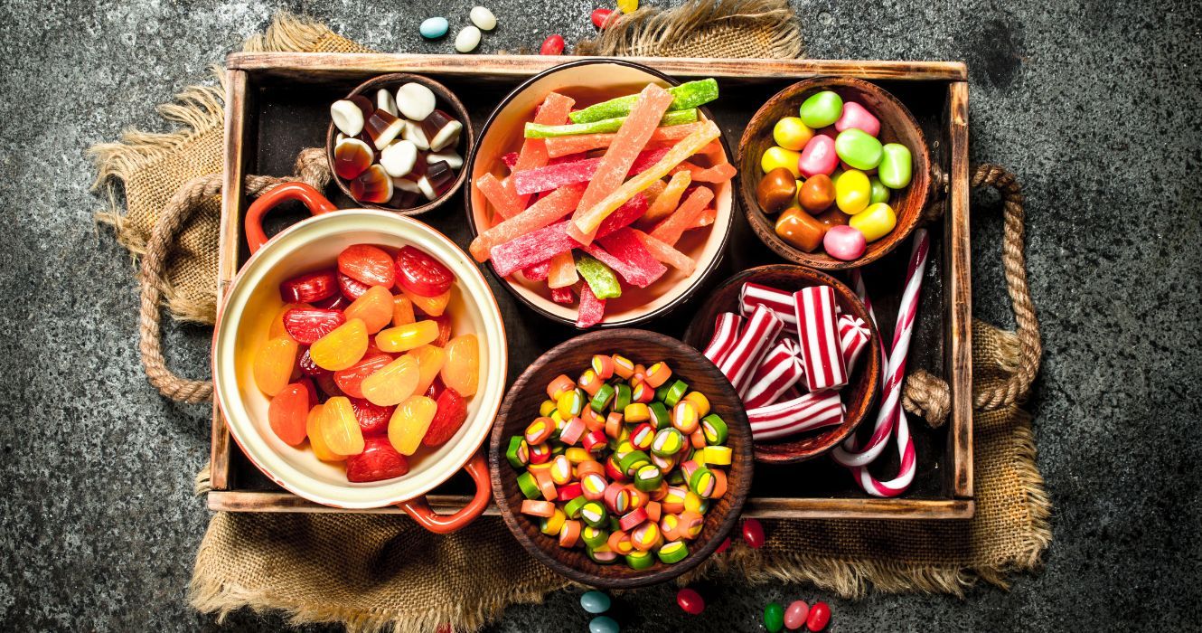a platter featuring bowls of mixed candies