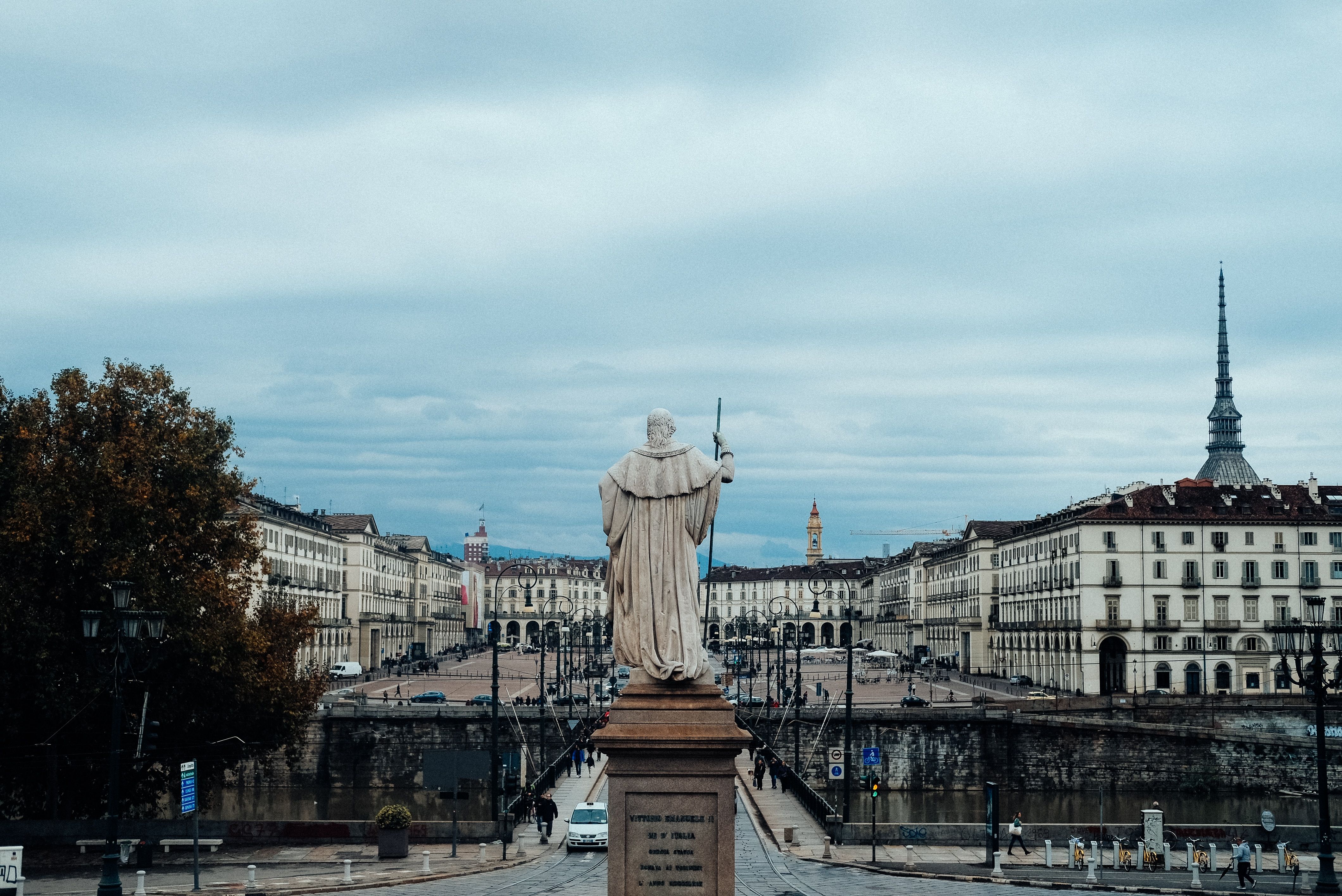 White statue in foreground with city 