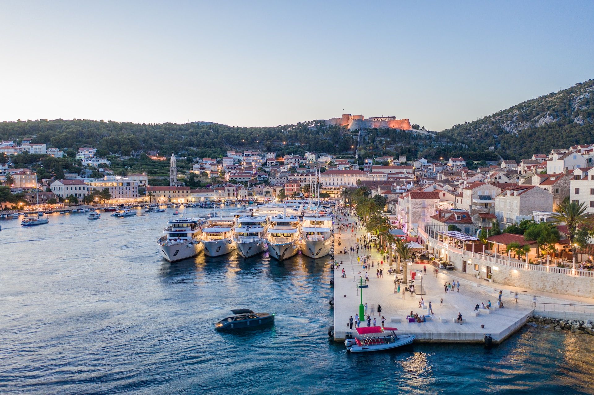Aerial view of Hvar, Croatia featuring boats and people  
