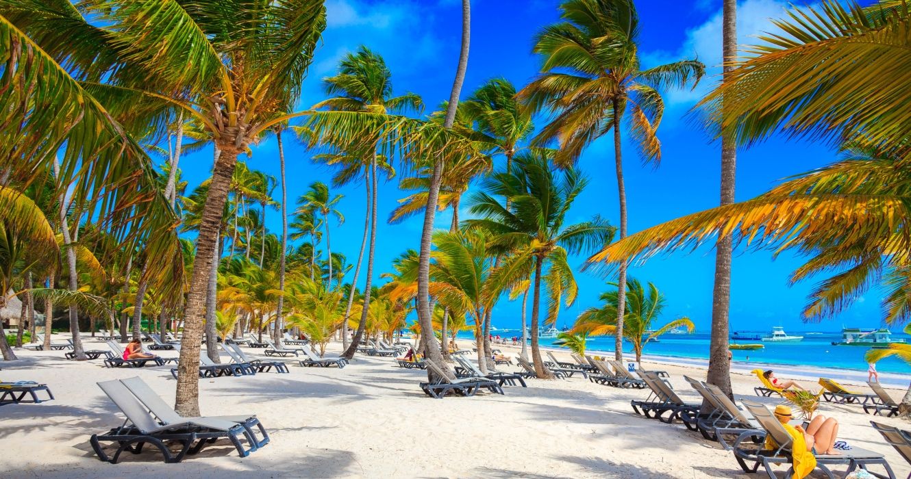 Loungers under the trees on a beach in Punta Cana