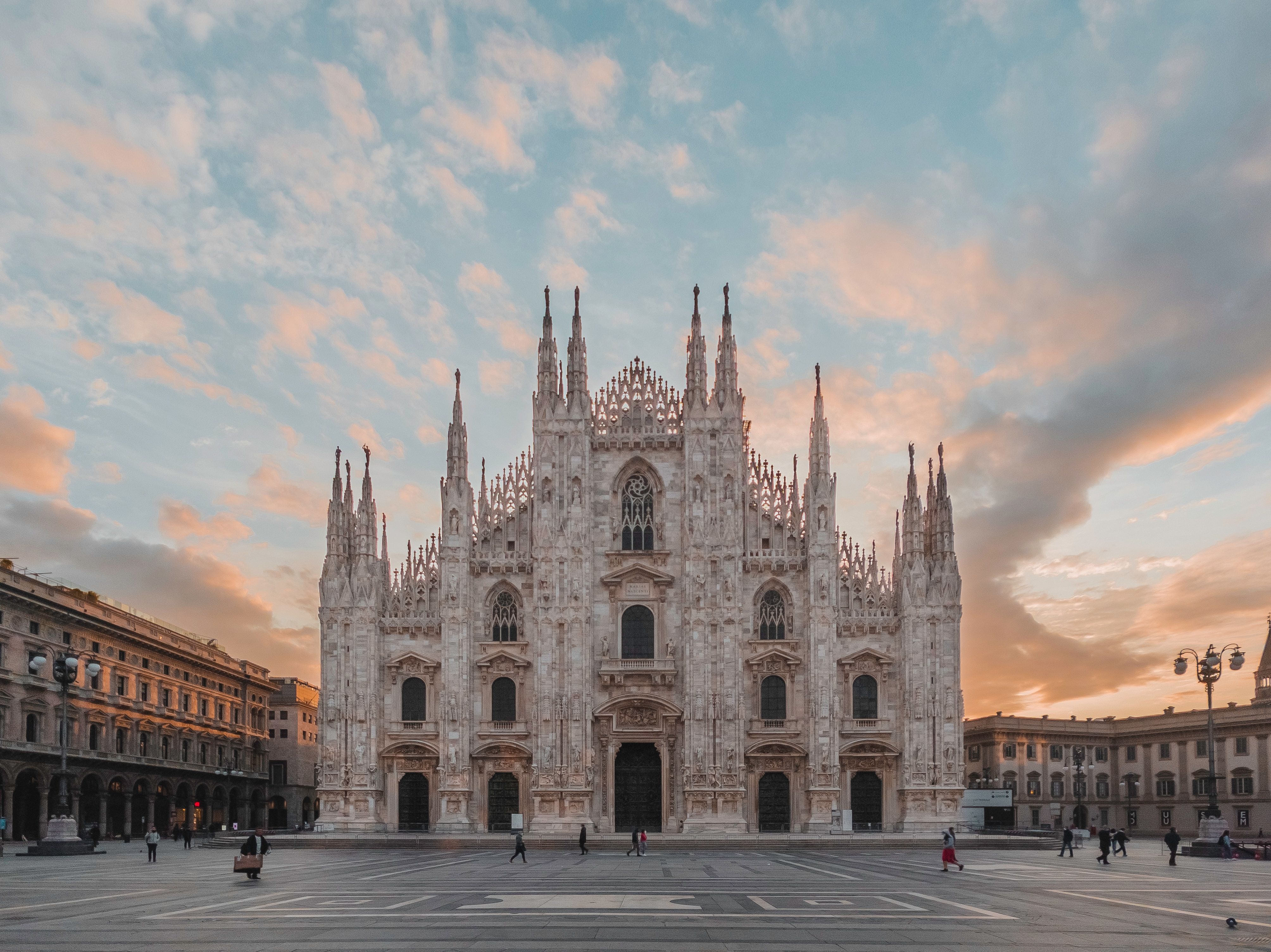 The sunset lingers over the Duomo di Milano, the second largest church in  Italy after St. Peter's Basilica in Rome …
