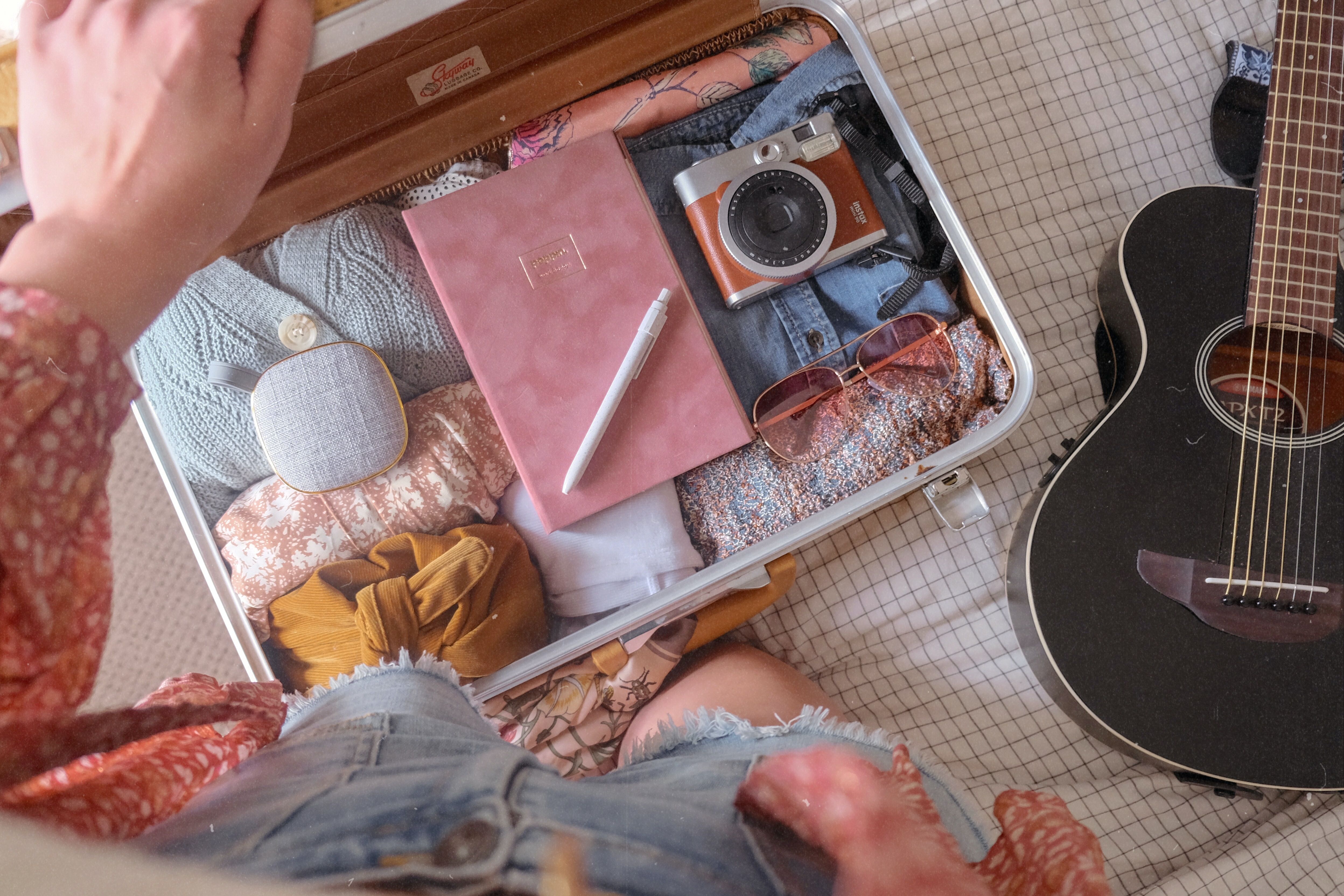 A person packing a small case