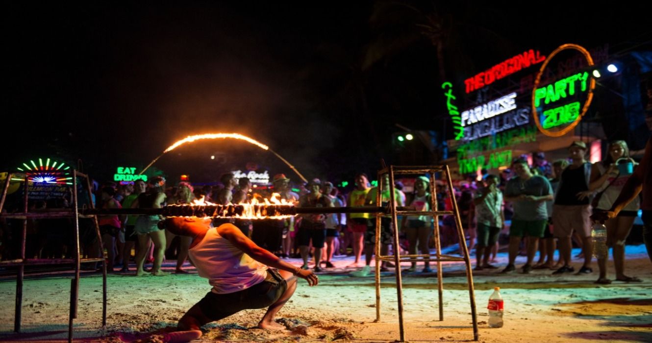 People partying on the beach during Full Moon Party in Koh Phangan, Surat Thani, Thailand