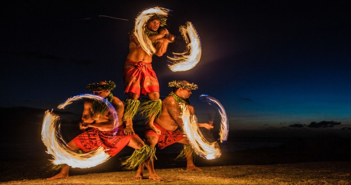 Three Hawaiian men fire dancing on the beach in Maui, Hawaii, USA
