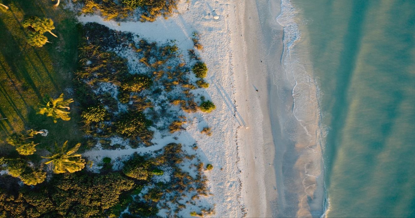 Aerial of people walking on the beach on Sanibel Captiva Island, Florida, USA