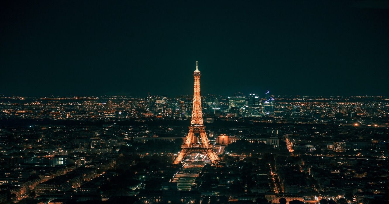 A city view of Paris at night with the Eiffel Tower lit up, Paris, France