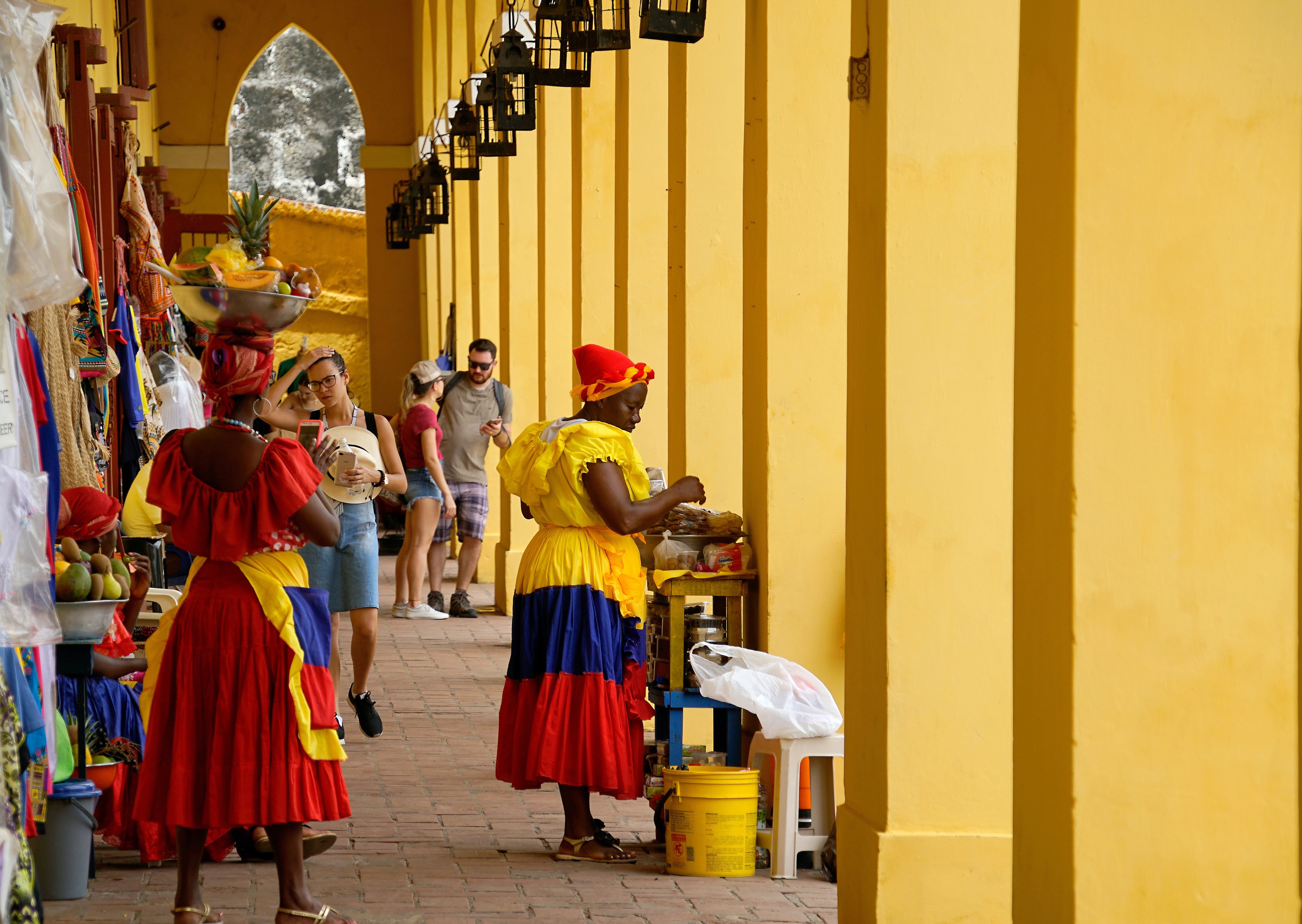 A market in Cartagena with women dressed in colorful clothing, Colombia 