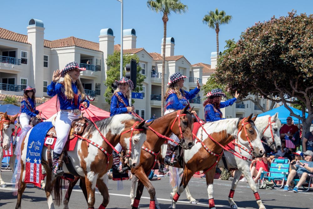 Cowgirls riding horses at the Huntington Beach Parade 4th of July Independence Day, California, USA