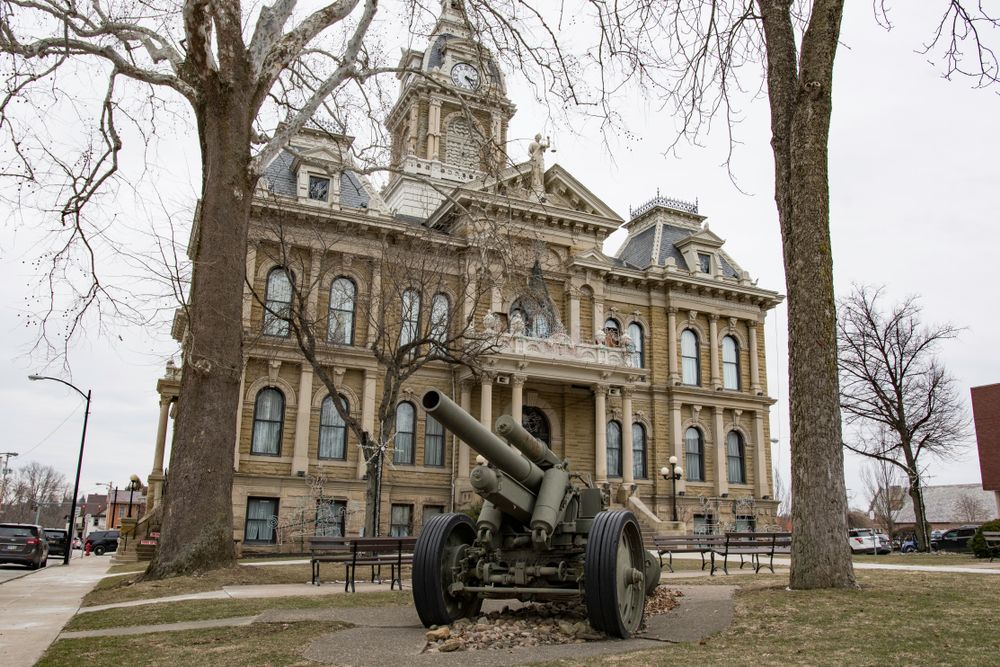 Military gun in front of the Guernsey County Courthouse in the square of downtown Cambridge, Ohio, that was built in 1883