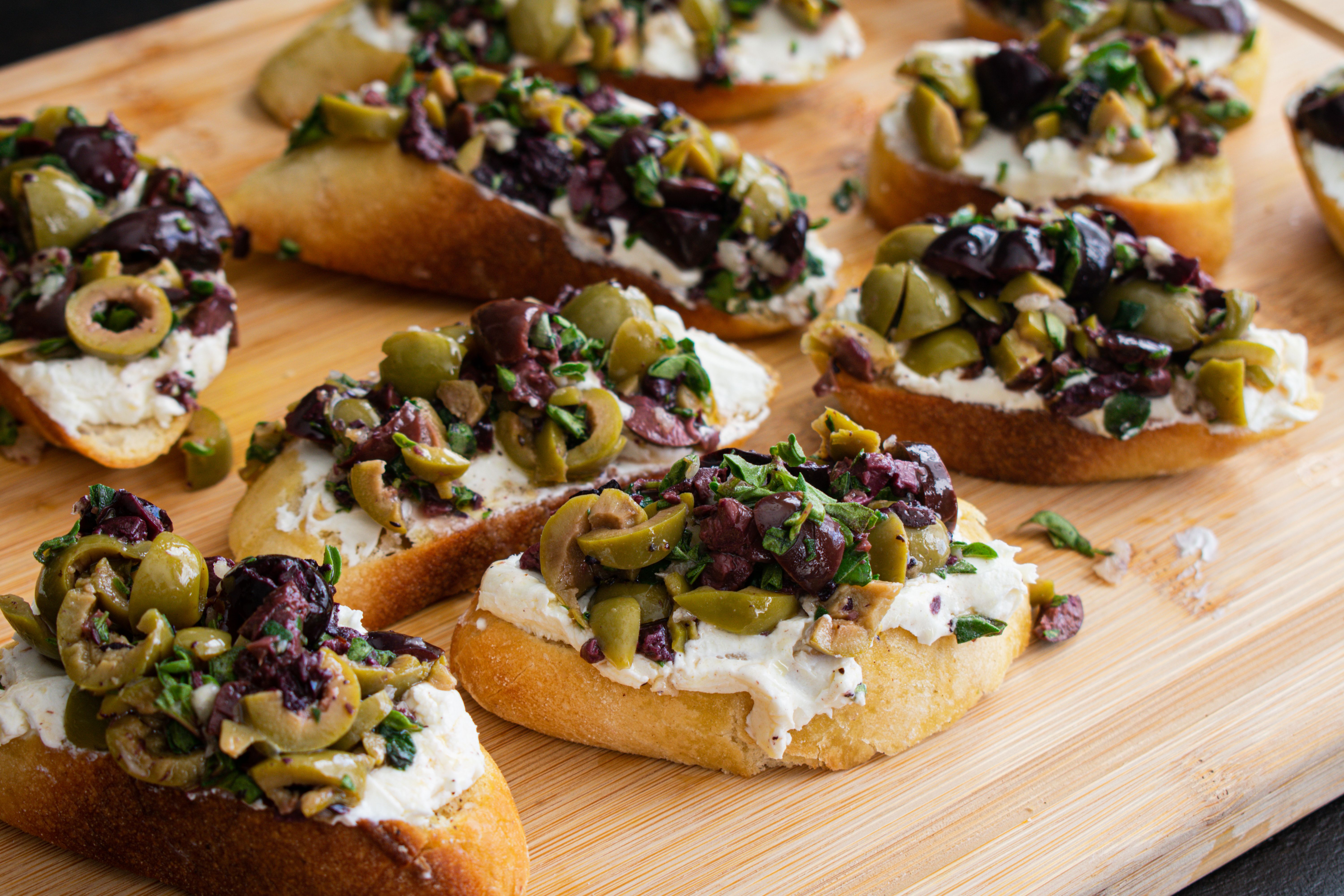 toasted bread with olives and cream cheese