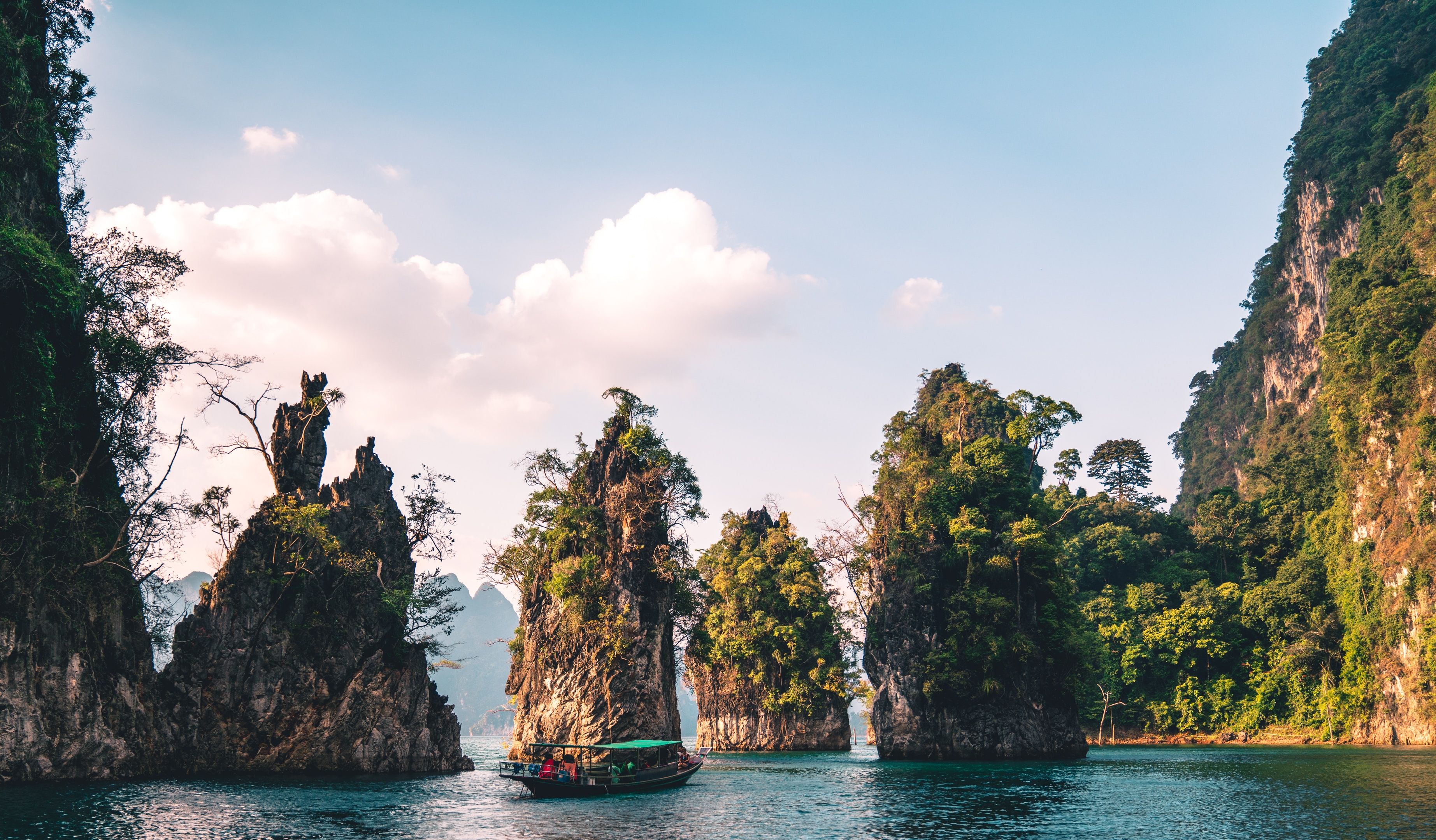 Dramatic rock formations emerge from the waters in Khao Sok National Park, Thailand 