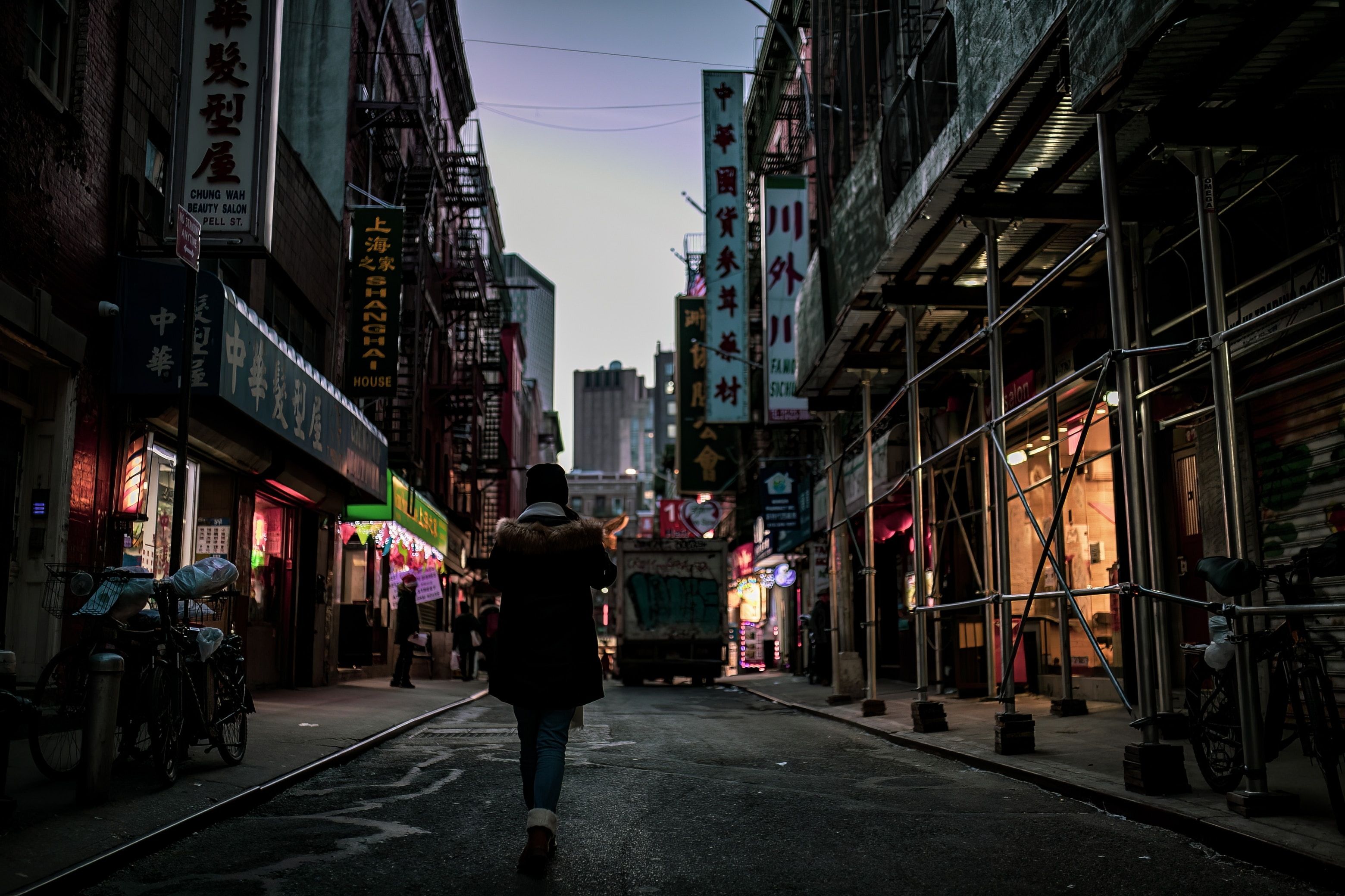 A tourist strolling through a street in Chinatown, Manhattan, NYC