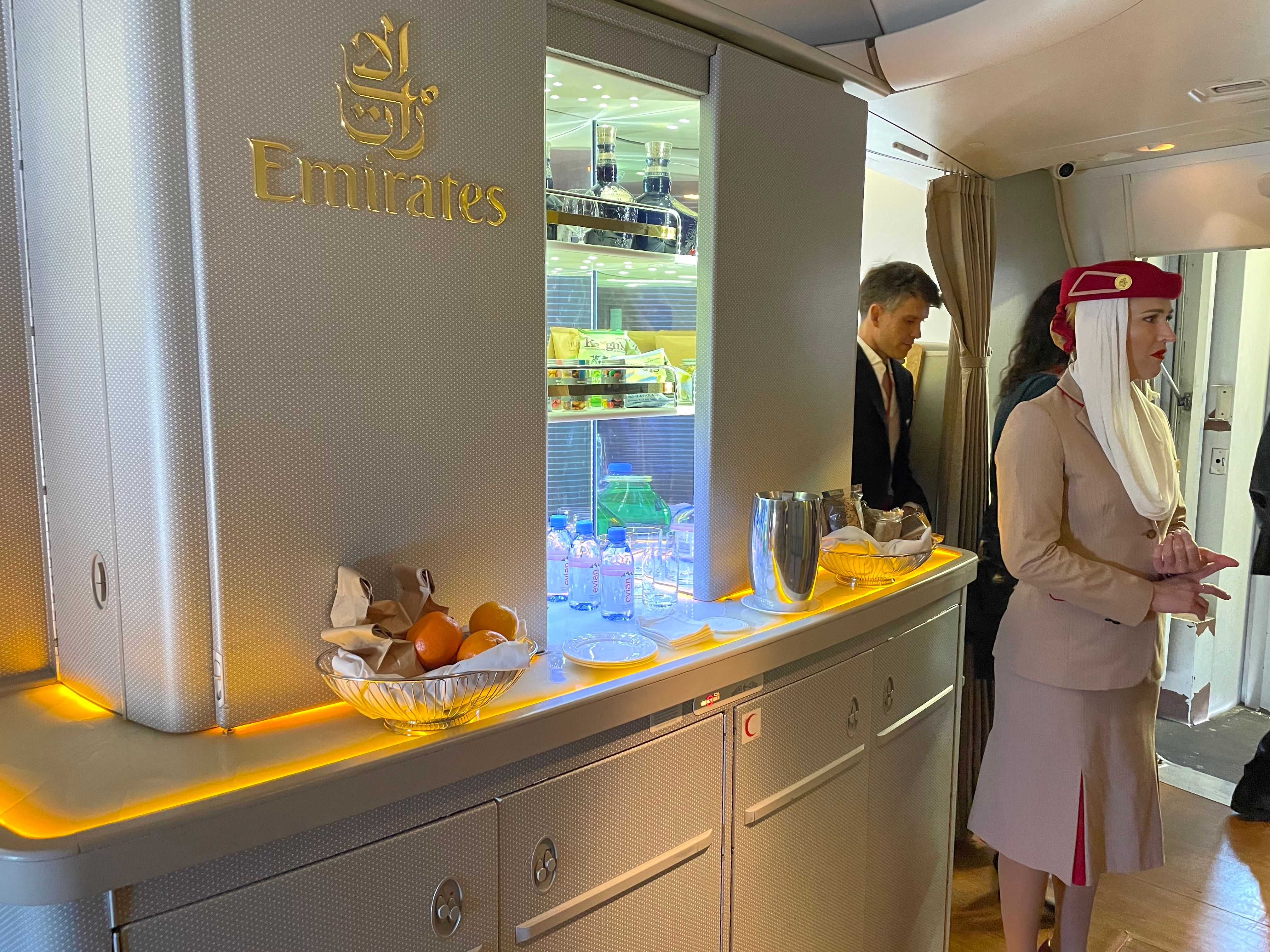 a flight attendant greets passengers on the new Emirates flight from Montreal to Dubai