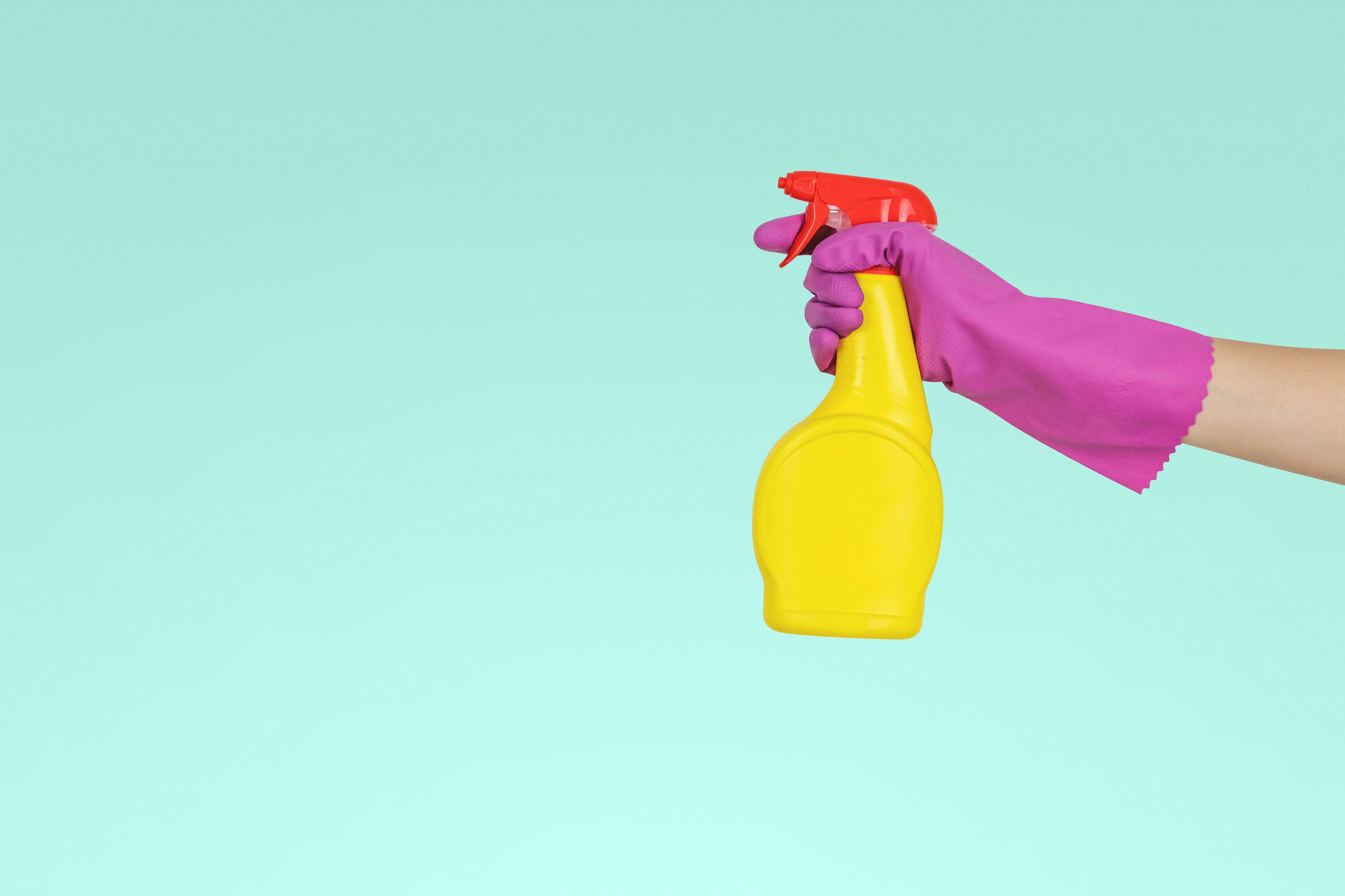 Person holding cleaning products