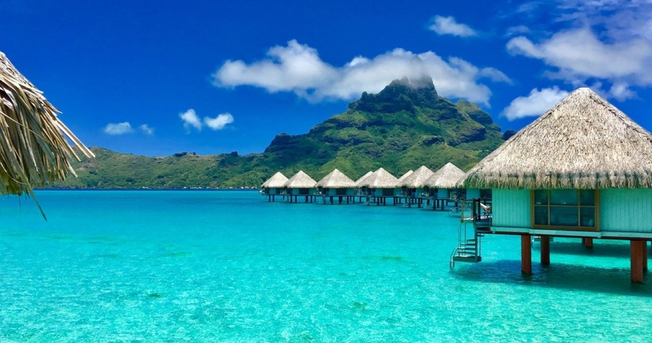 Overwater bungalows of a luxury resort providing a view on the Otemanu, Bora Bora, Tahiti, French Polynesia