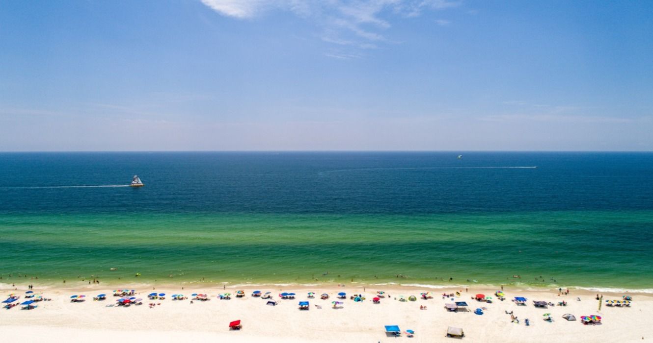 Aerial view of the white sands and blue green ocean Gulf Shores, the best Alabama beach,