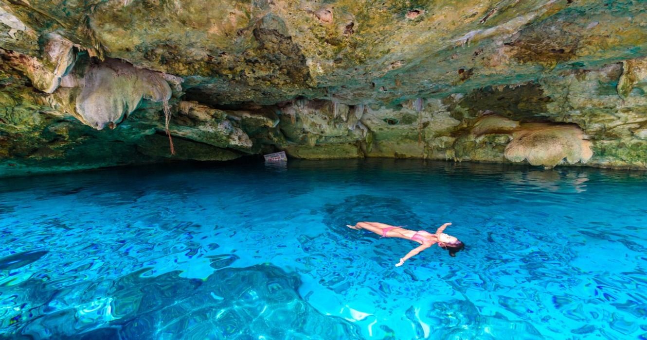 A person swimming in Cenote Dos Ojos in Quintana Roo, Mexico