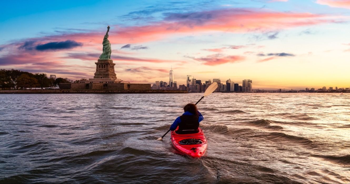 A person kayaking near the Statue of Liberty in Jersey City, New Jersey, United States