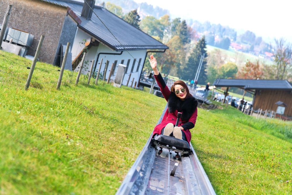 Young girl traveller enjoys alpine coaster