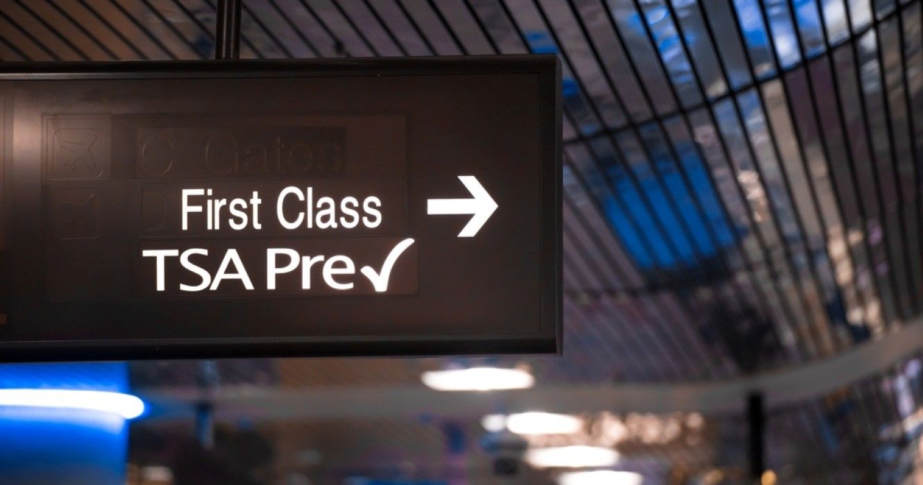 Sign showing security check point lanes designated for first class and TSA Precheck passengers