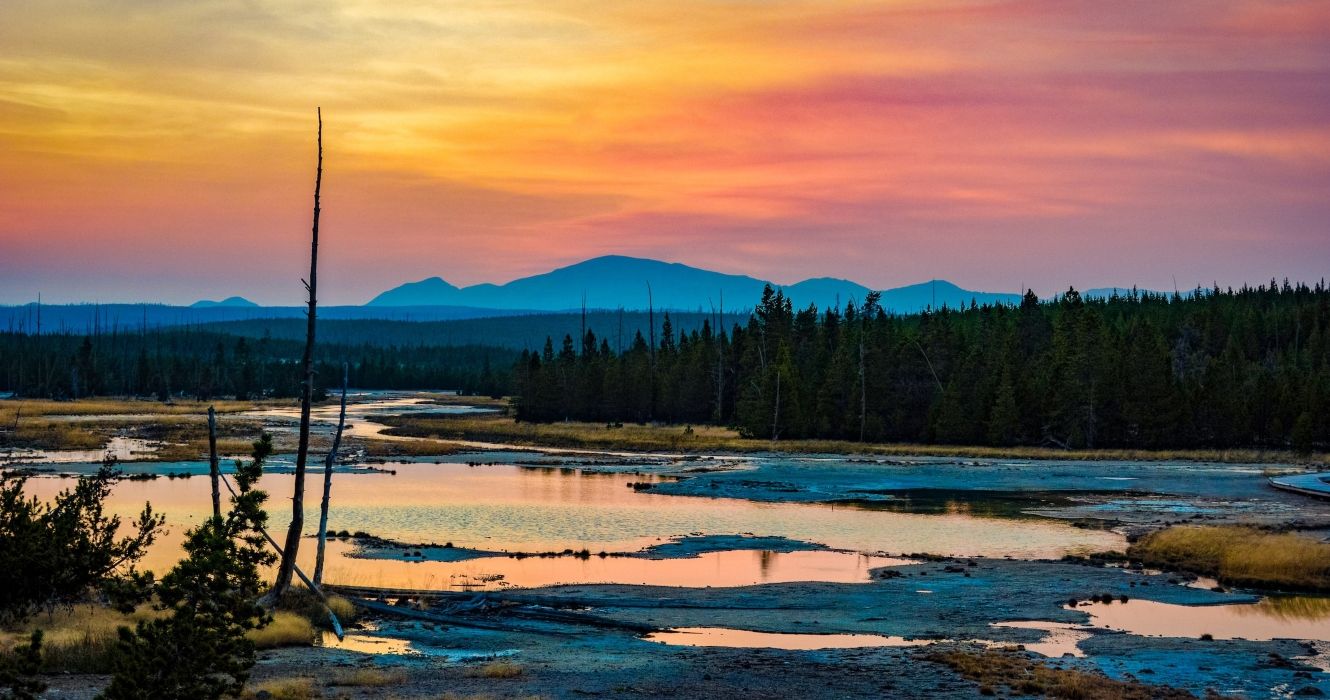 Sunset with water on the ground at Yellowstone National Park
