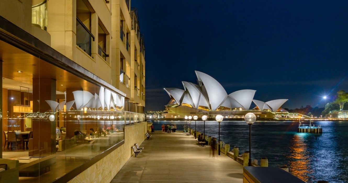 Sydney Opera House reflected in the windows of the Park Hyatt Hotel at night, Sydney, Australia