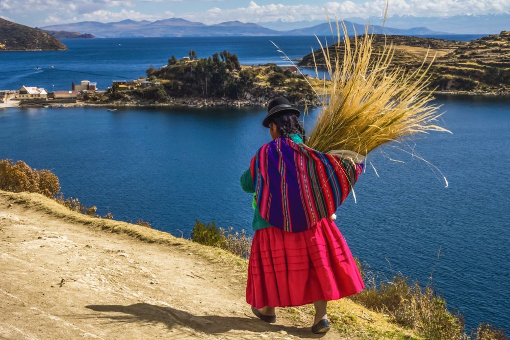 Traditional Bolivian woman in traditional dress at Lake Titicaca