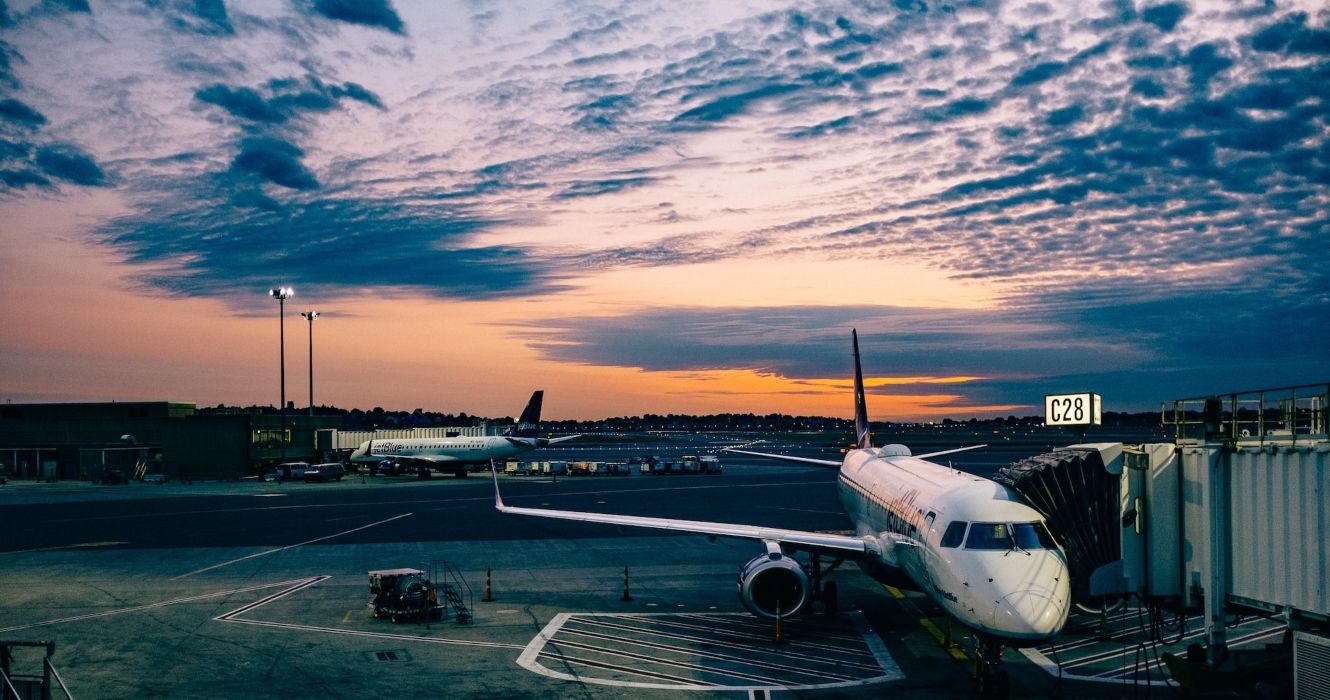 Airplanes On The Tarmac At An Airport At Sunset In Logan Airport Terminal C, United States