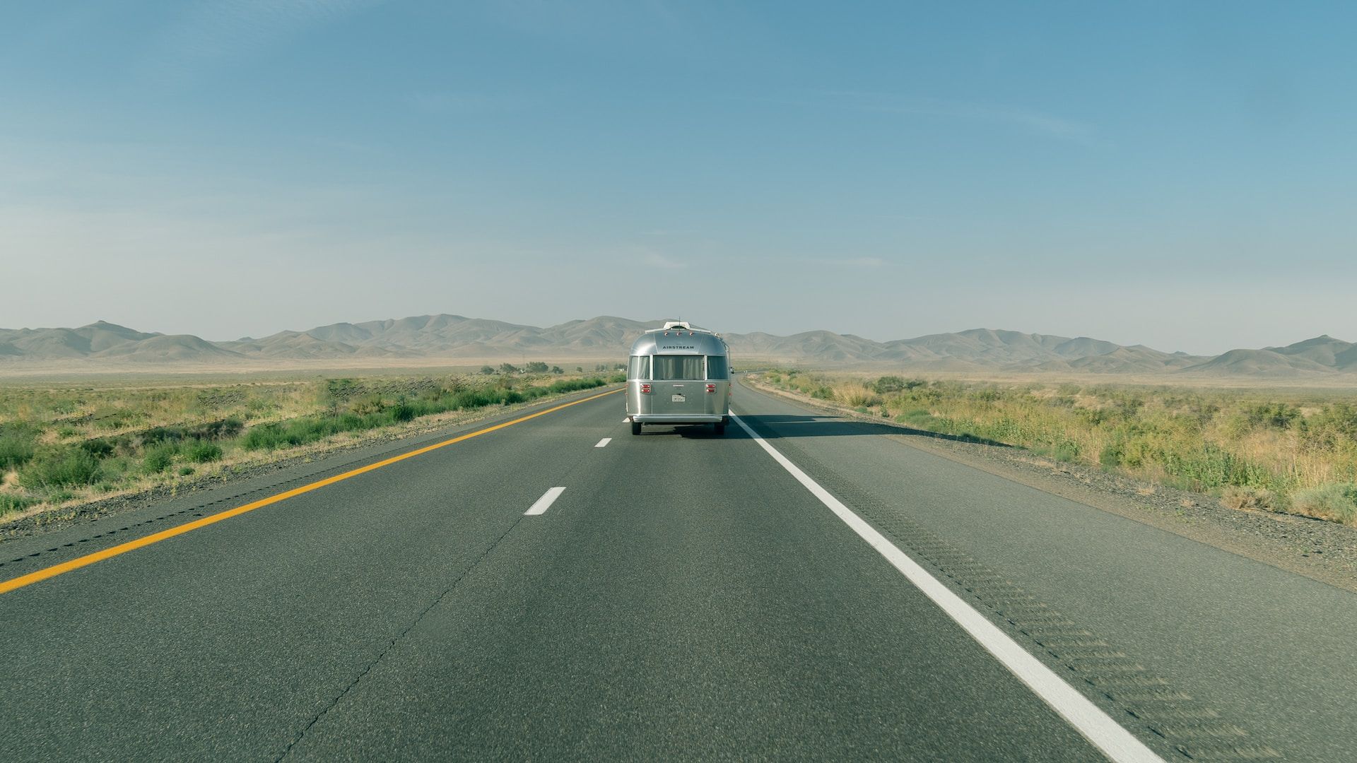 A Trailer Driving Down The Road In Utah, USA