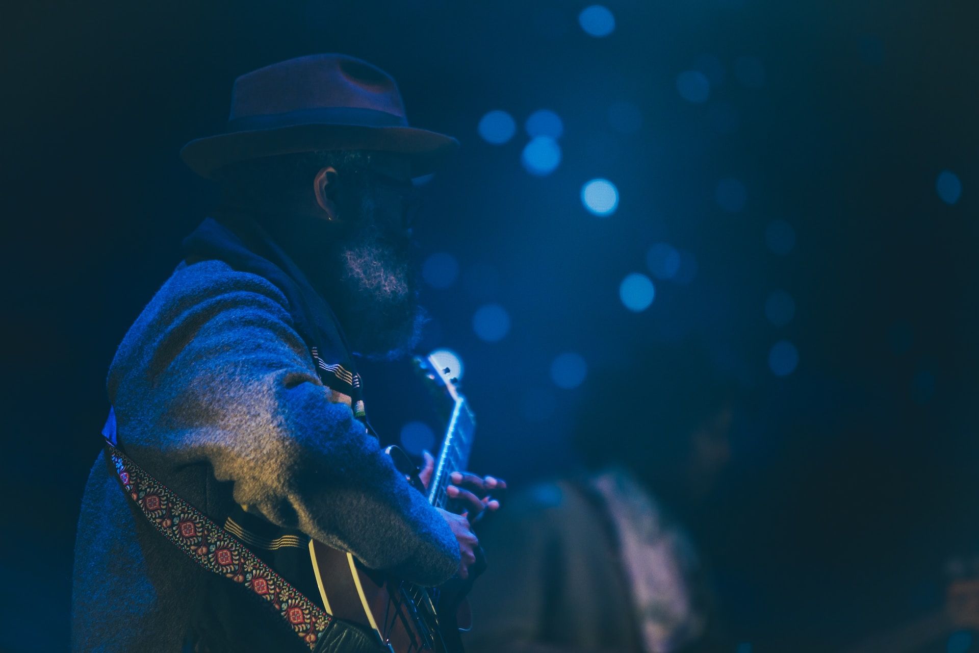 Blues musician performing in a darkened room