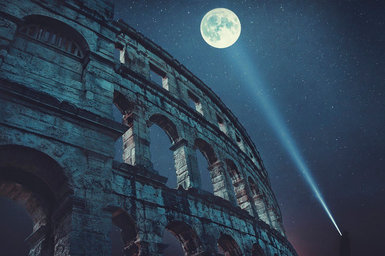Colosseum of Rome at night with the moon