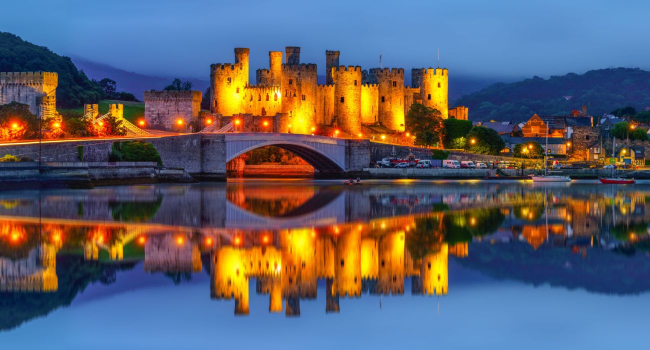 Conwy Castle at night reflecting off the water