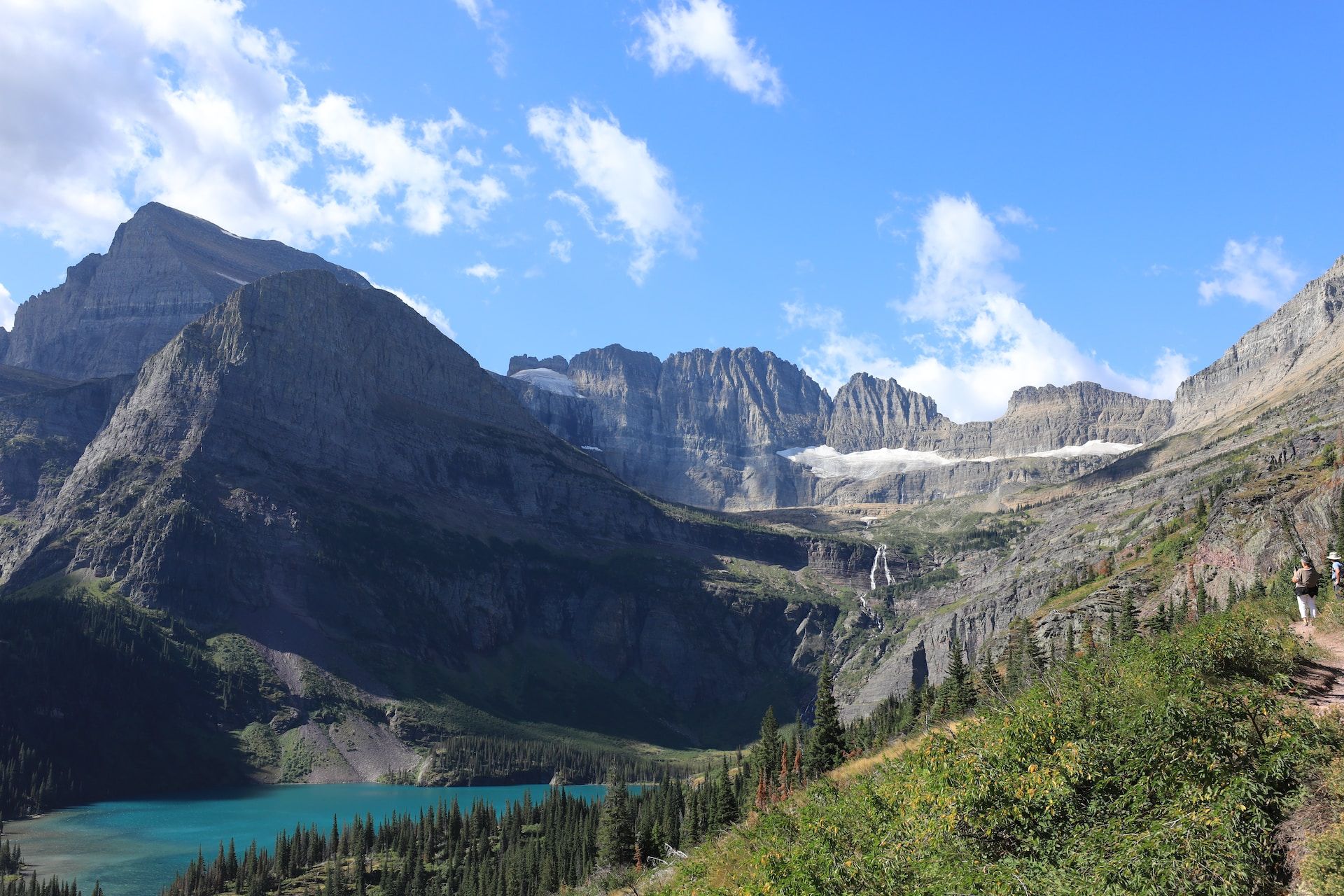 A view of Grinnell Lake between mountains, in Glacier National Park