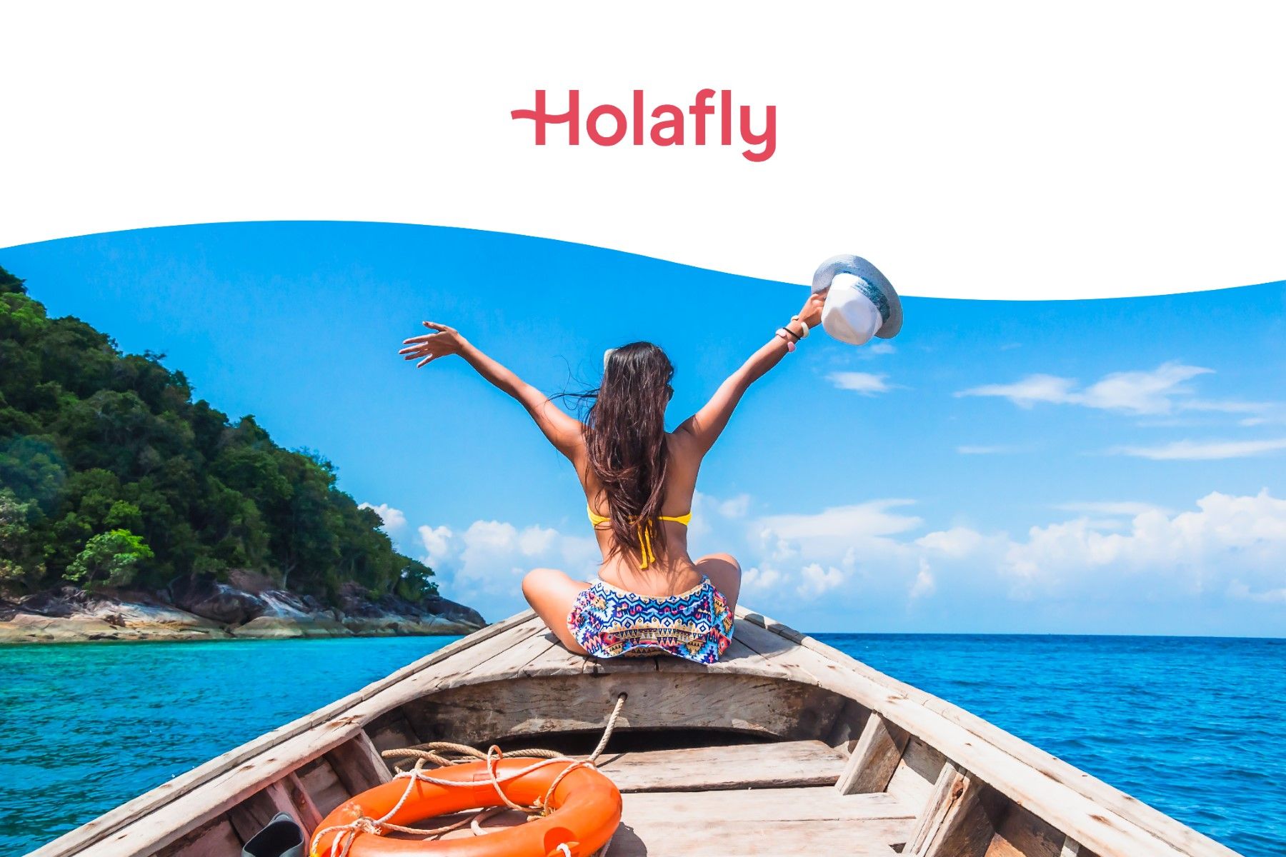 A female traveler sitting on the bow of a boat in the sea