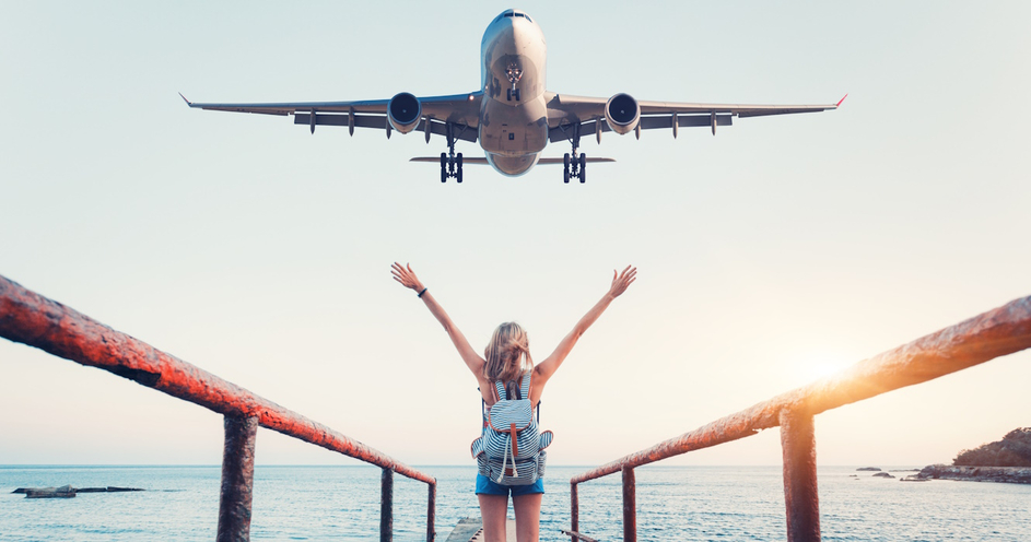 Woman waving at airplane