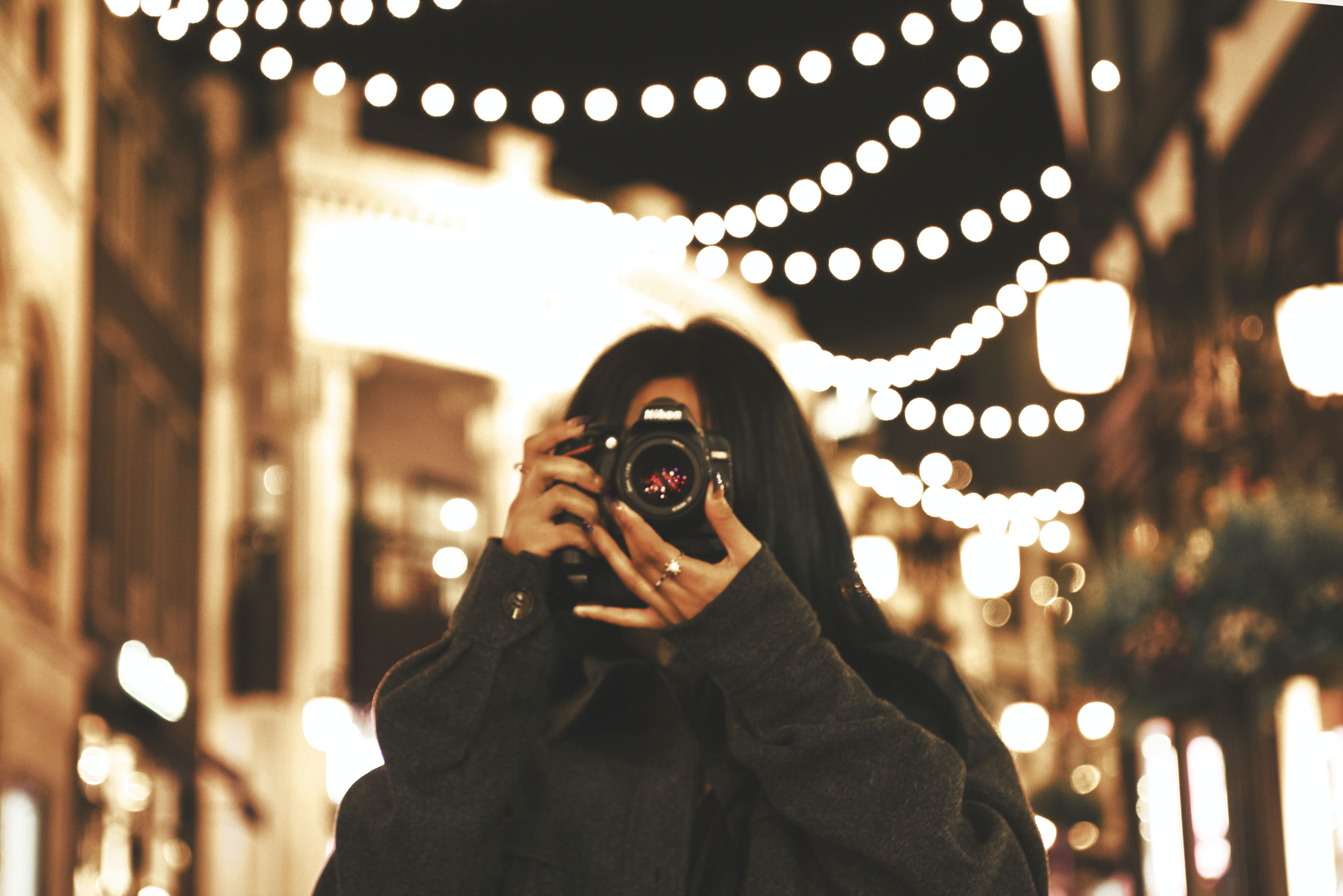 A woman holding a camera in Beverly Center, L.A.