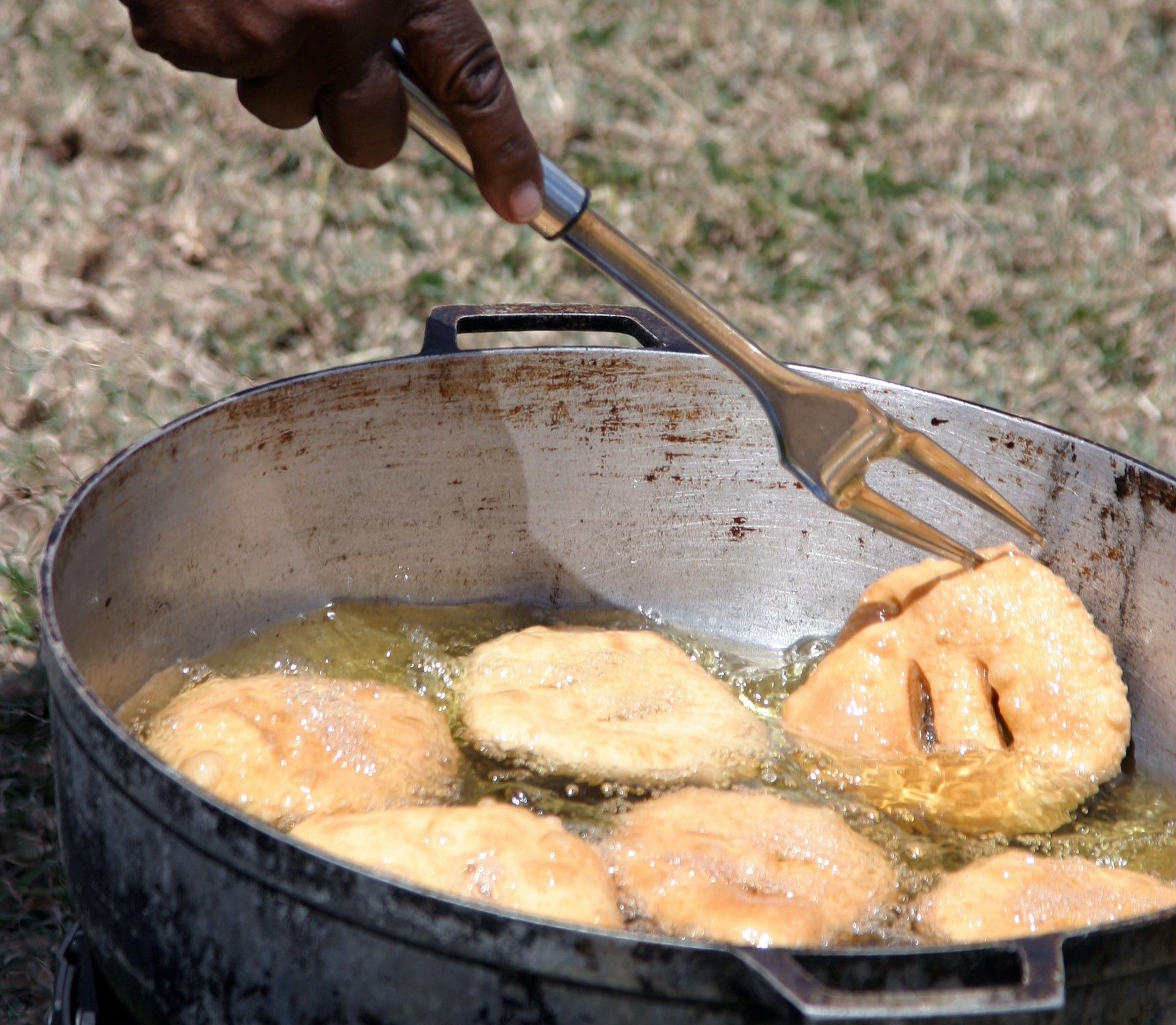 A Person Frying Donuts In A Pan In St. Thomas, Virgin Islands, USA