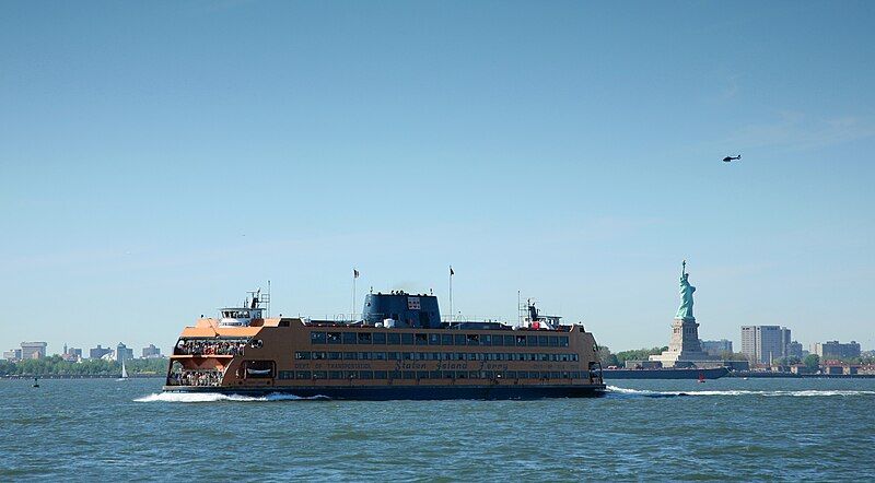 Staten Island Ferry With The Statue Of Liberty In The Background In Manhattan, New York 