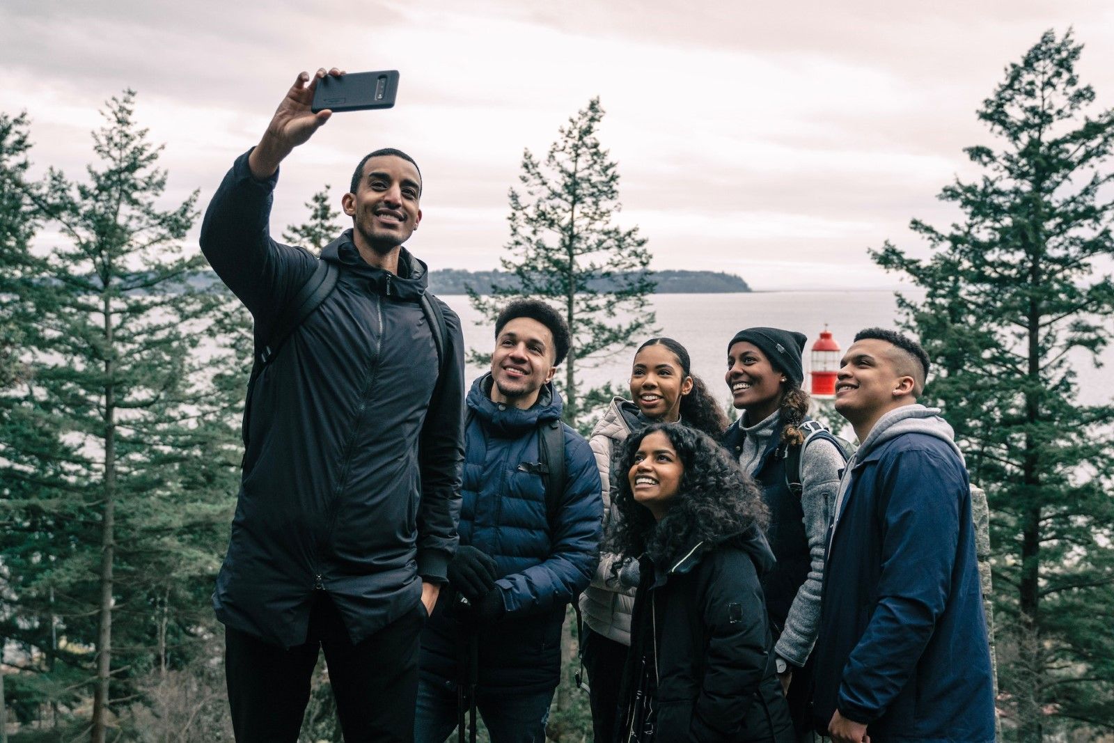 A group of friends taking a selfie at a scenic spot 