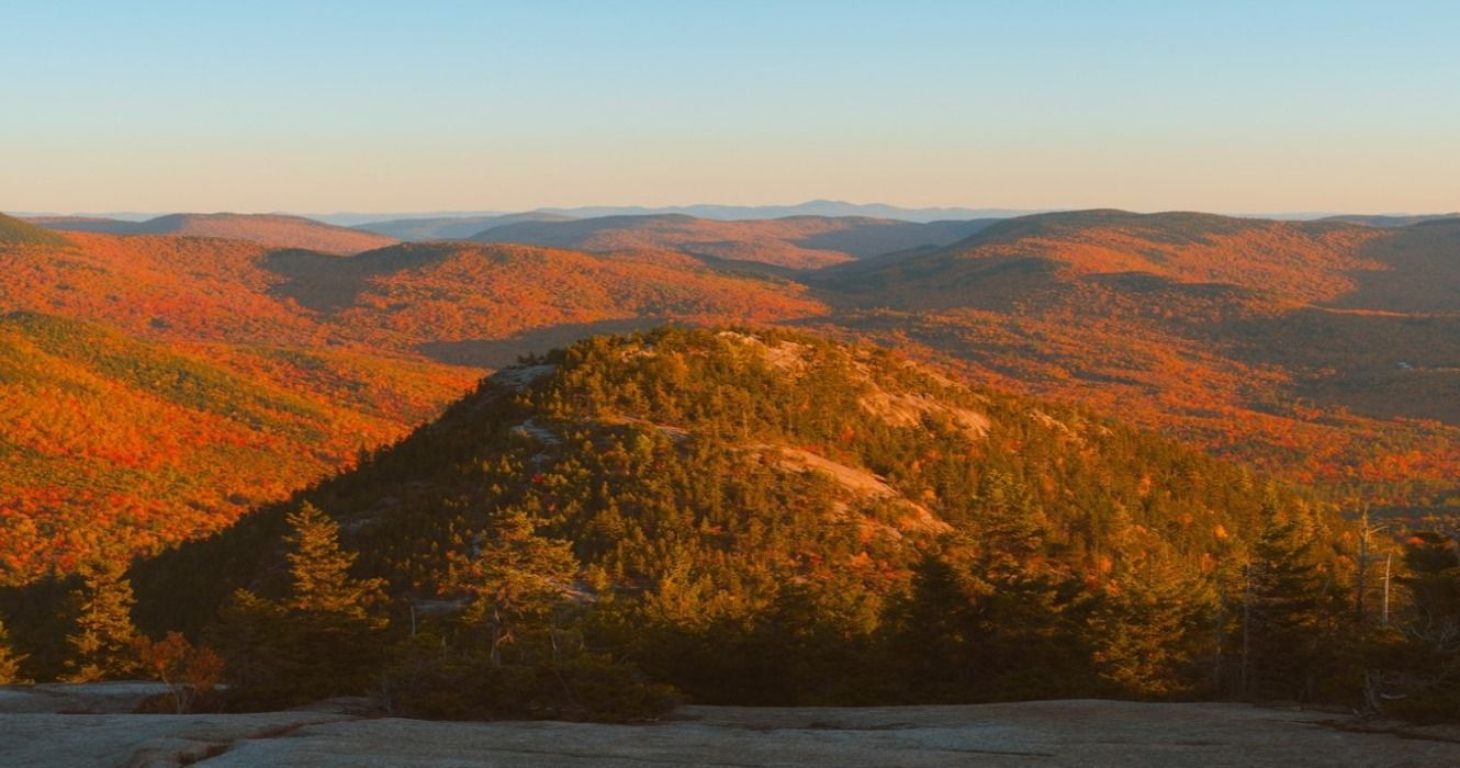 Sunset and fall foliage at Welch Mountain seen from Dickey Mountain in the White Mountains, New Hampshire, USA