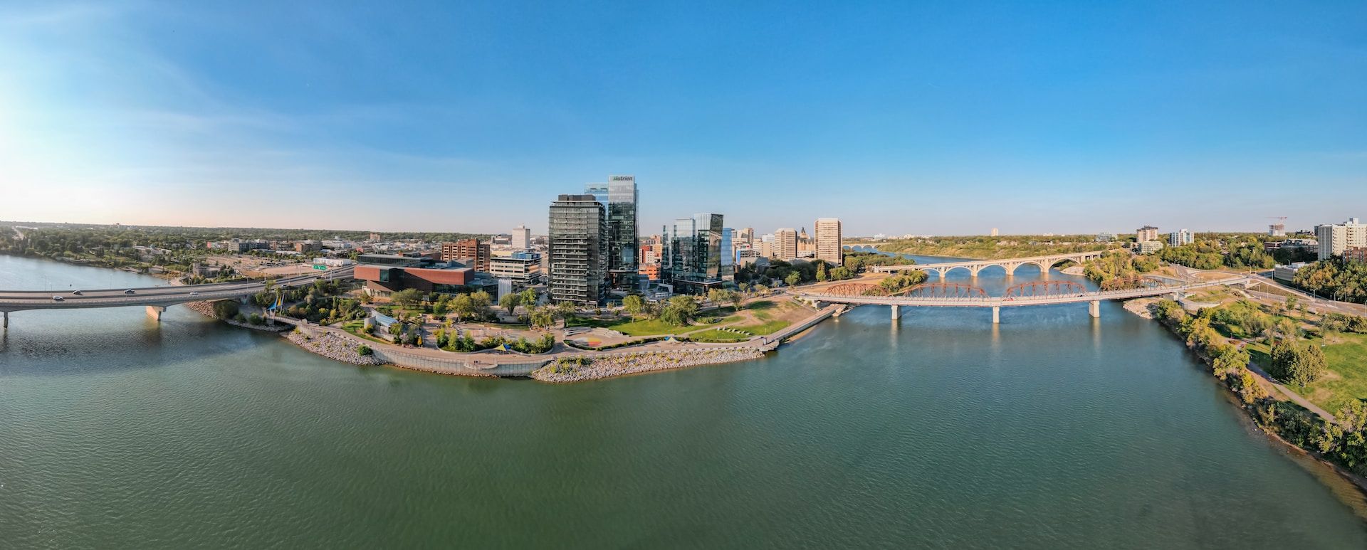 Drone view of Saskatoon with highrises and office buildings in a distance, Saskatchewan, Canada 