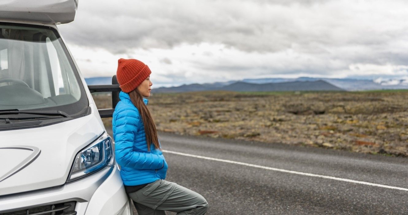 RV camper trailer travel woman driving motorhome camping van on Iceland road trip