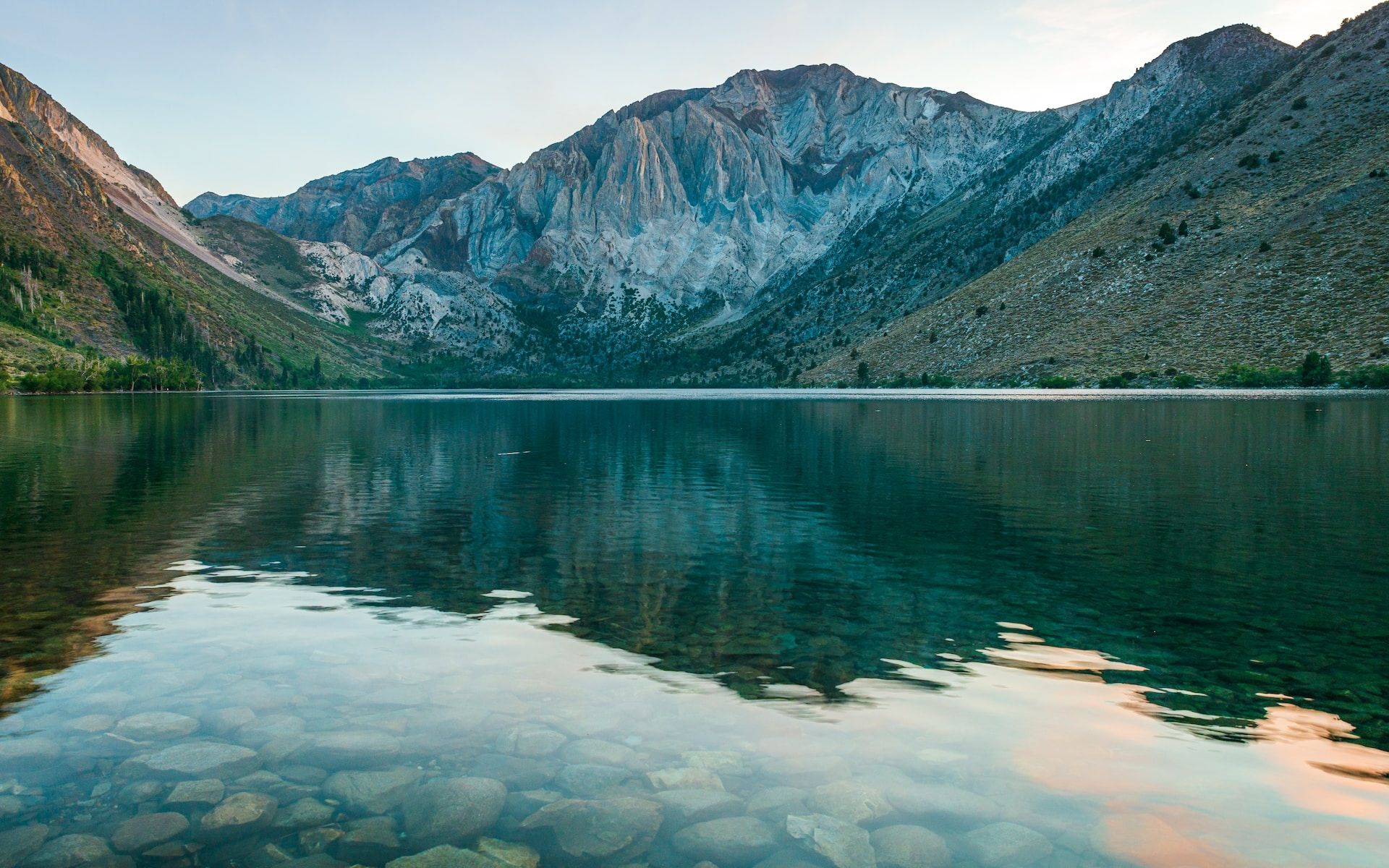 The clear waters of Convict Lake with mountains in the background