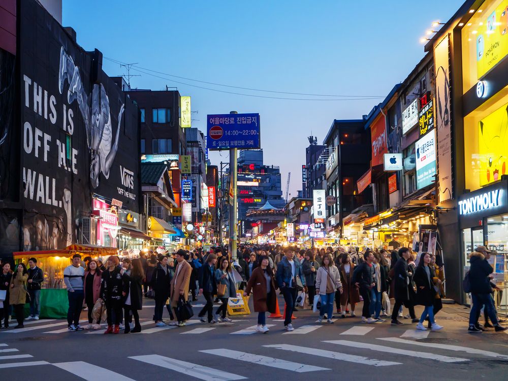 Group of people shopping and walking at Hongdae street market in Seoul, South Korea