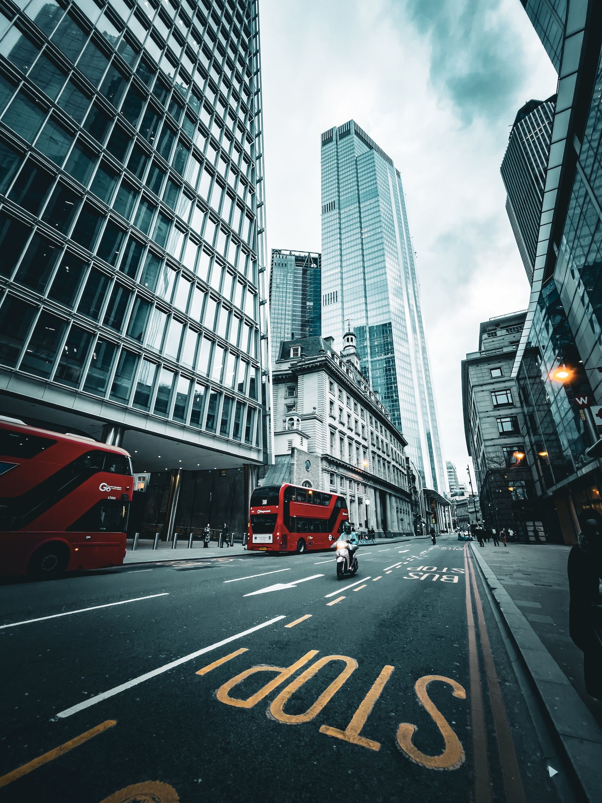 London street with double-decker buses and towering buildings, UK 