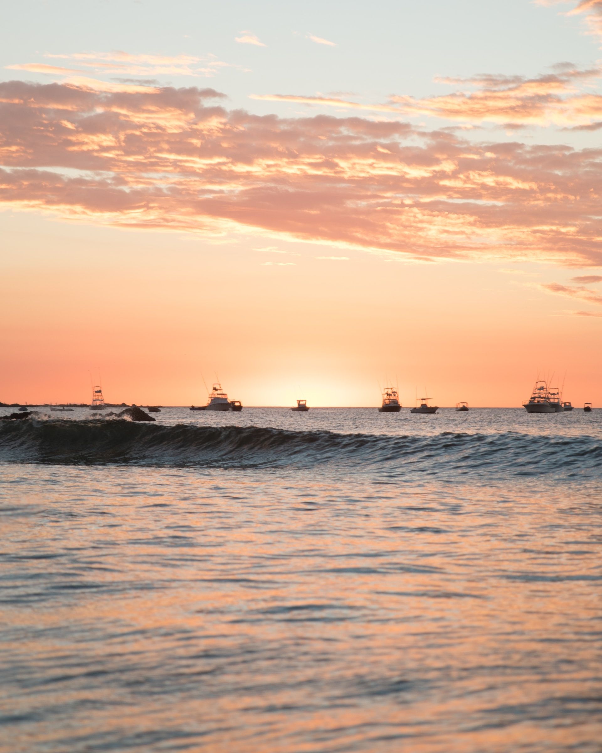 Fishing boats on the water at sunset in Tamarindo, Costa Rica