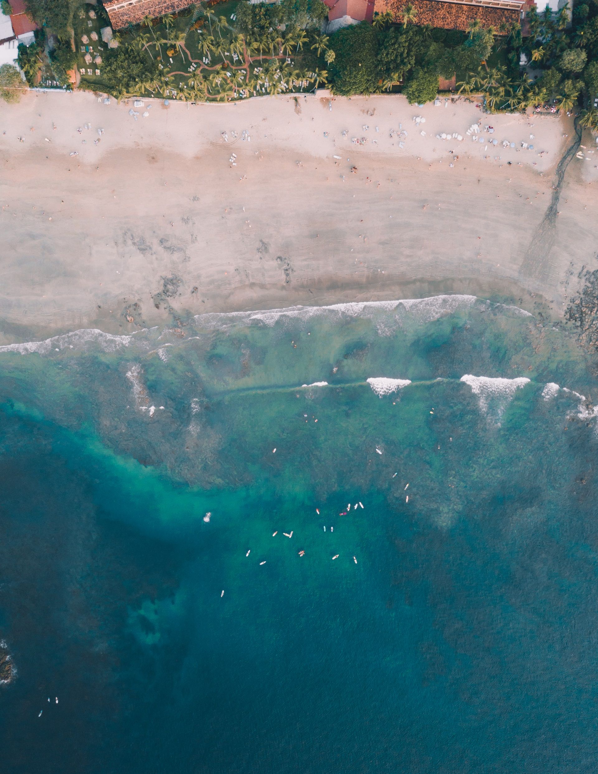 Aerial view of blue water and the shoreline in Tamarindo, Costa Rica